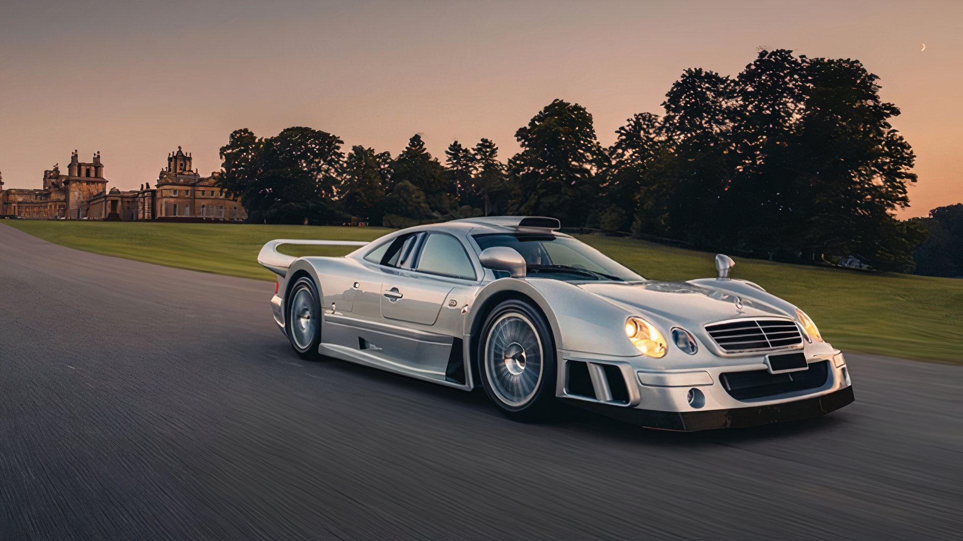 1998 Mercedes-Benz CLK-GTR in silver driving on country estate road