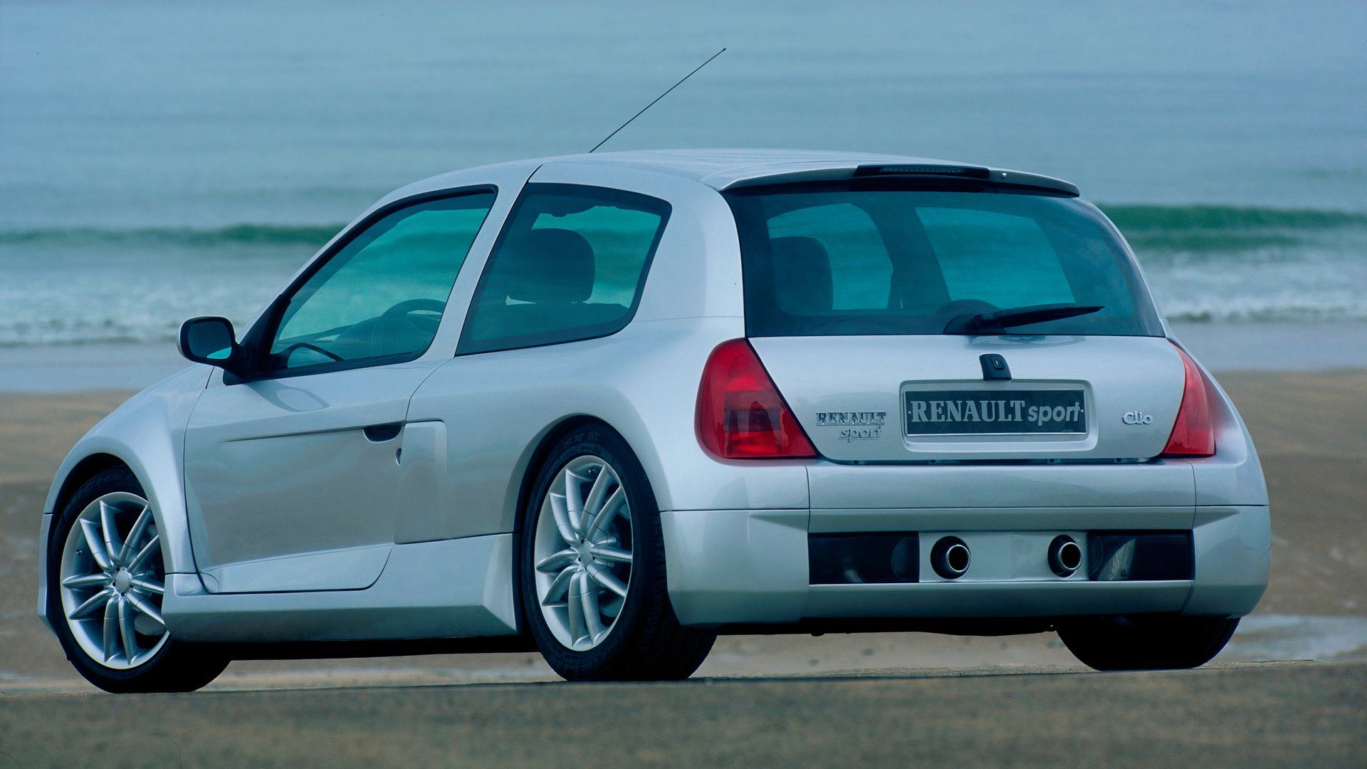 Renault Clio Sport V6 rear 3/4 exterior shot on a beach