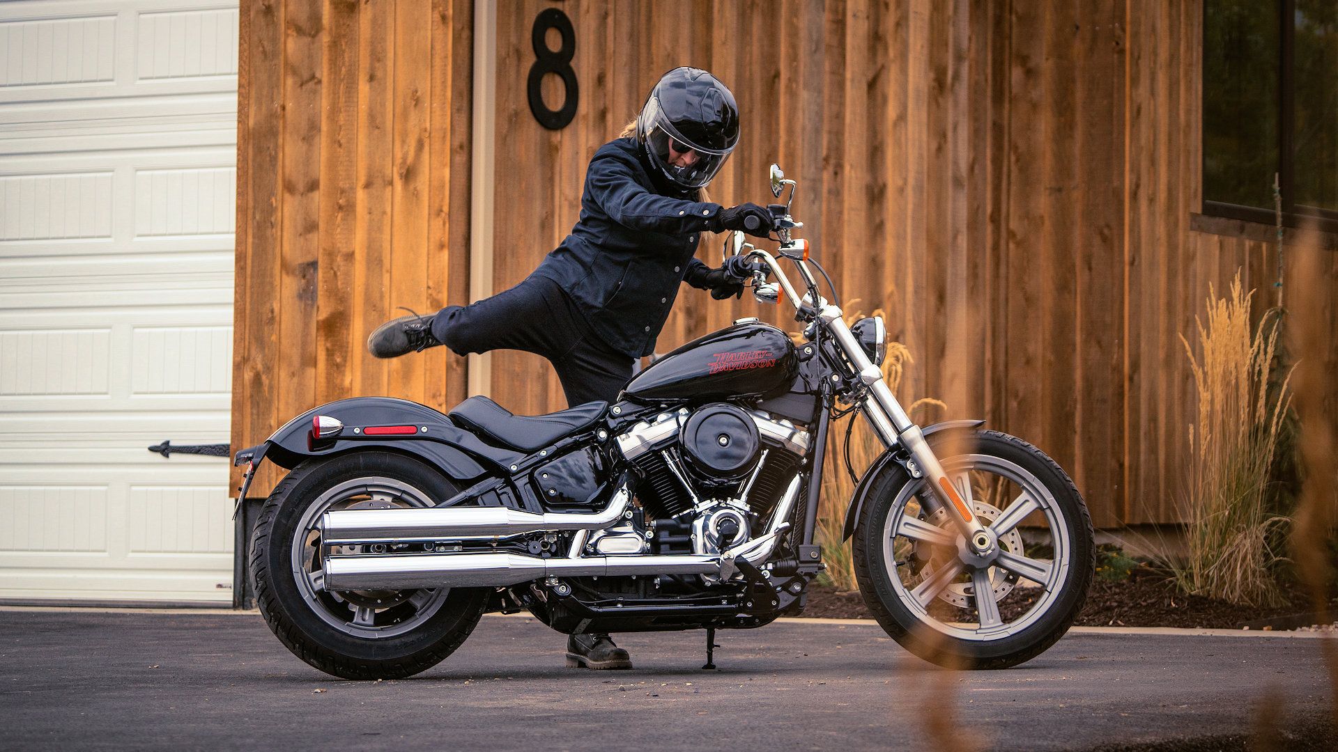 Rider mounting a 2024 Harley-Davidson Softail Standard