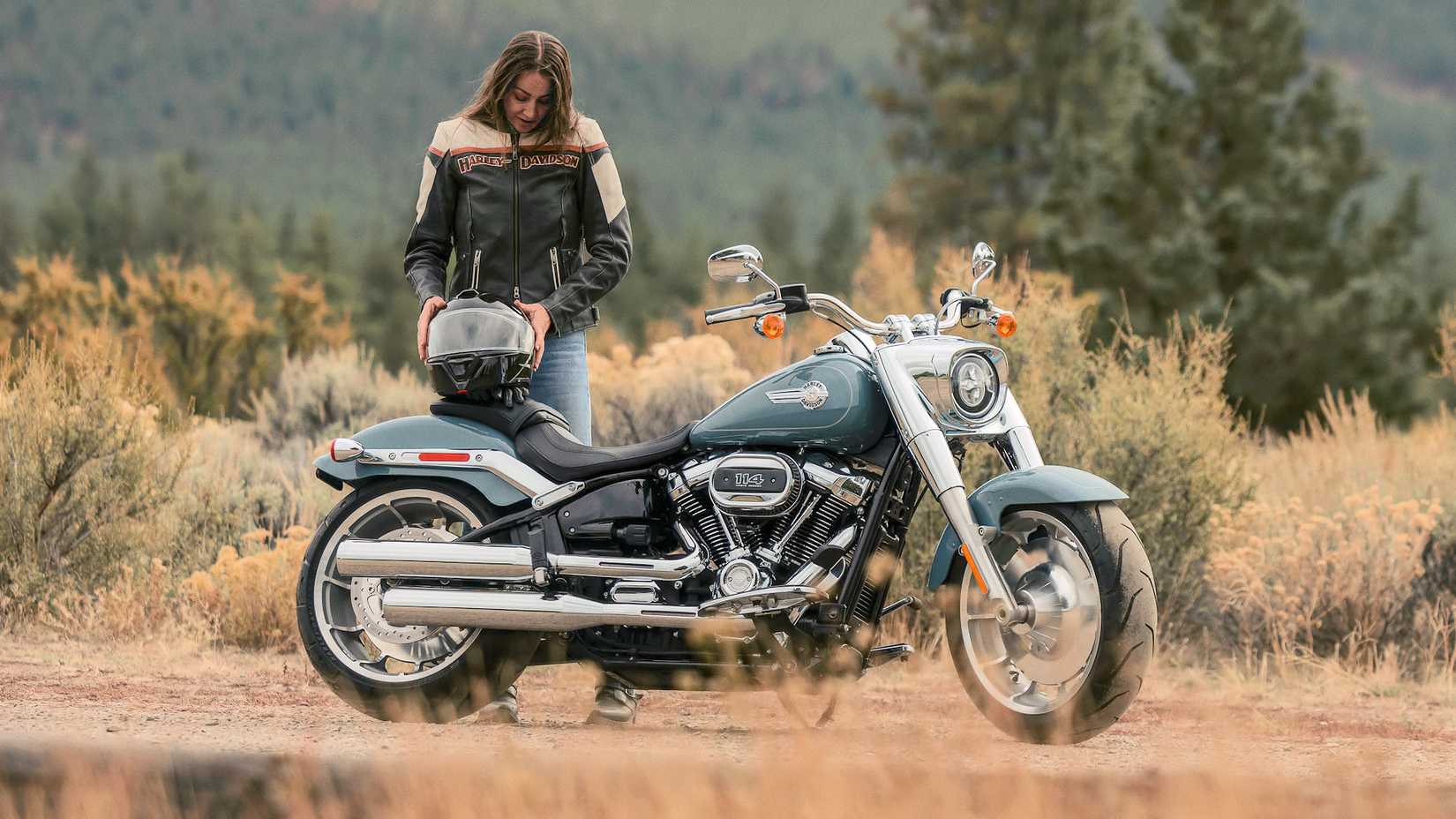 Rider next to a 2024 Harley-Davidson Fat Boy 114