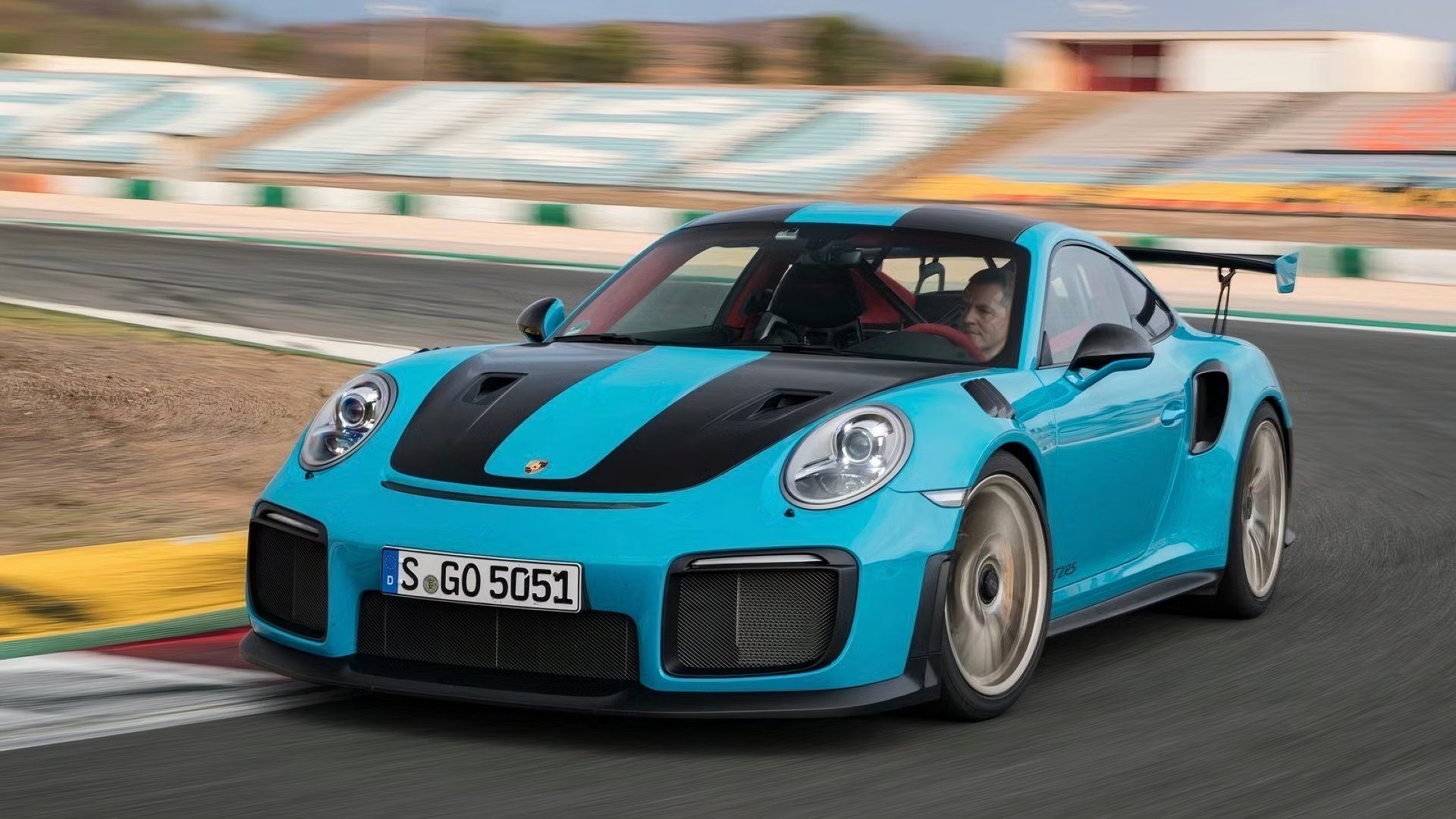 Front 3/4 view of Blue 2018 Porsche 911 GT2 RS driving on track.