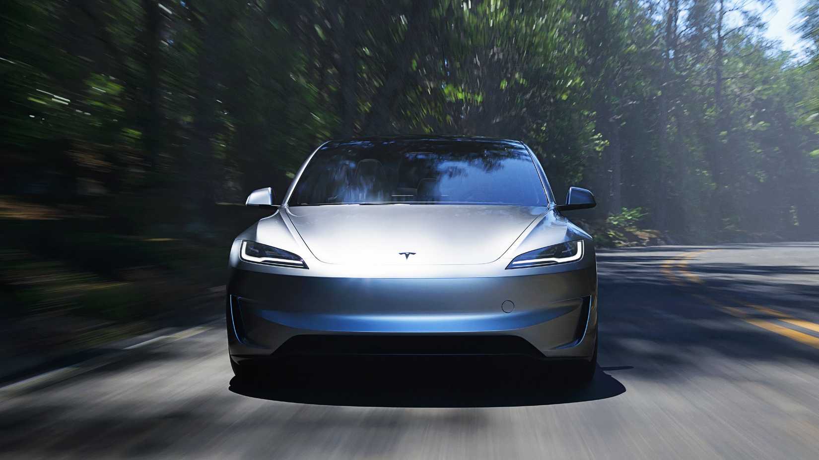 A gray Tesla Model 3 Performance is driving. 