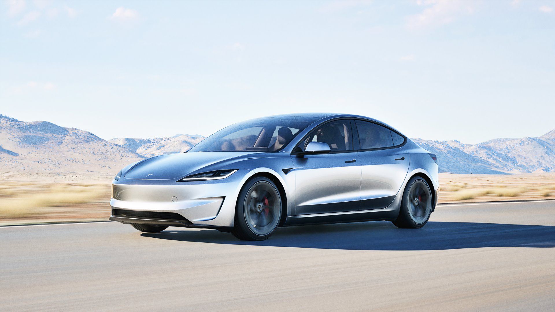 A gray 2024 Tesla Model 3 Performance is driving on the road. 