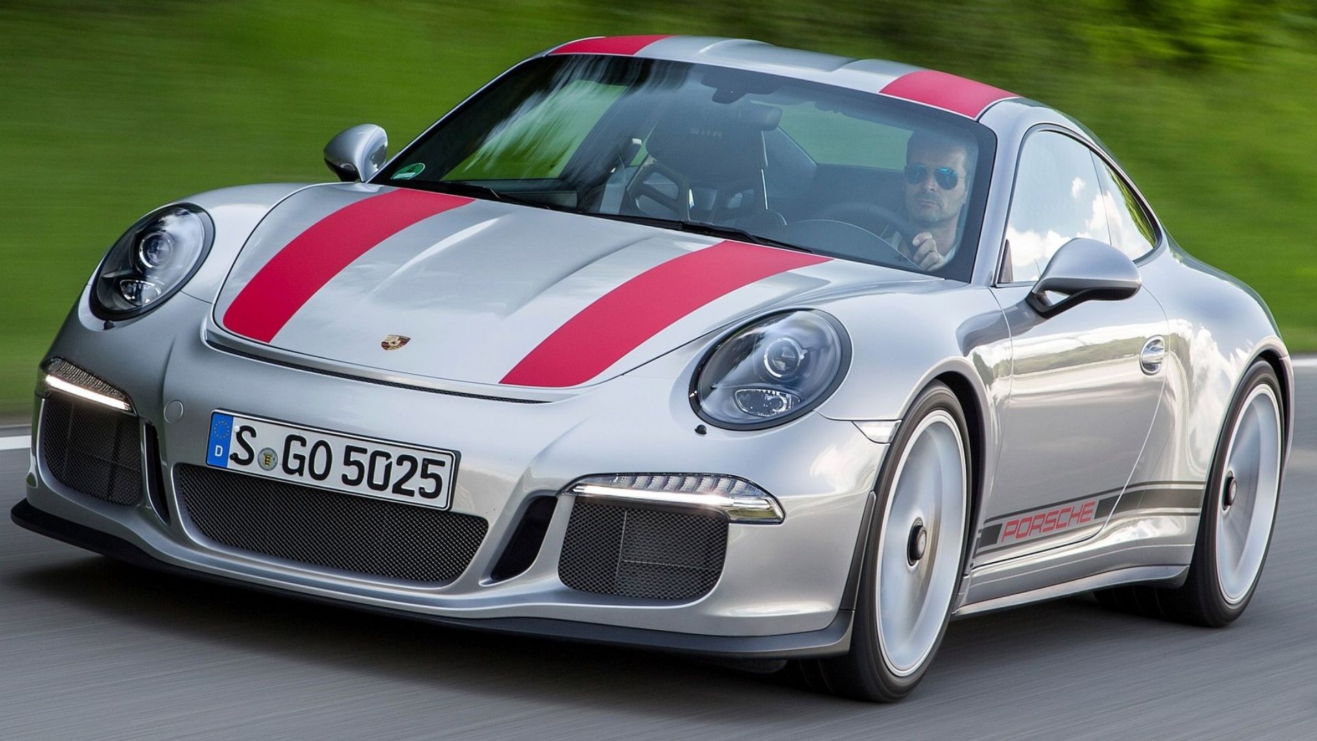 Silver 2017 Porsche 911 R driving on road