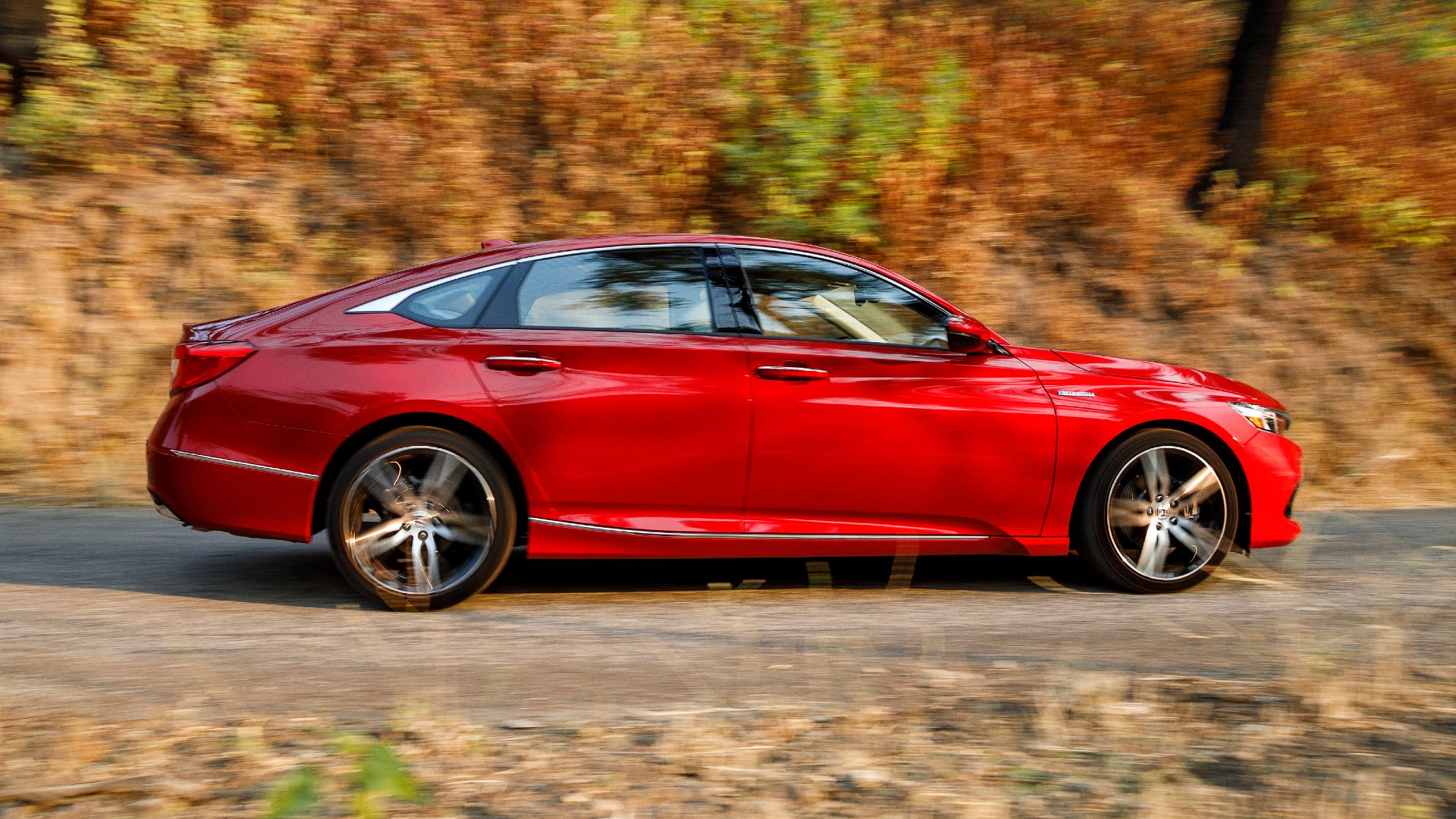 Side profile shot of a red 2021 Honda Accord Hybrid