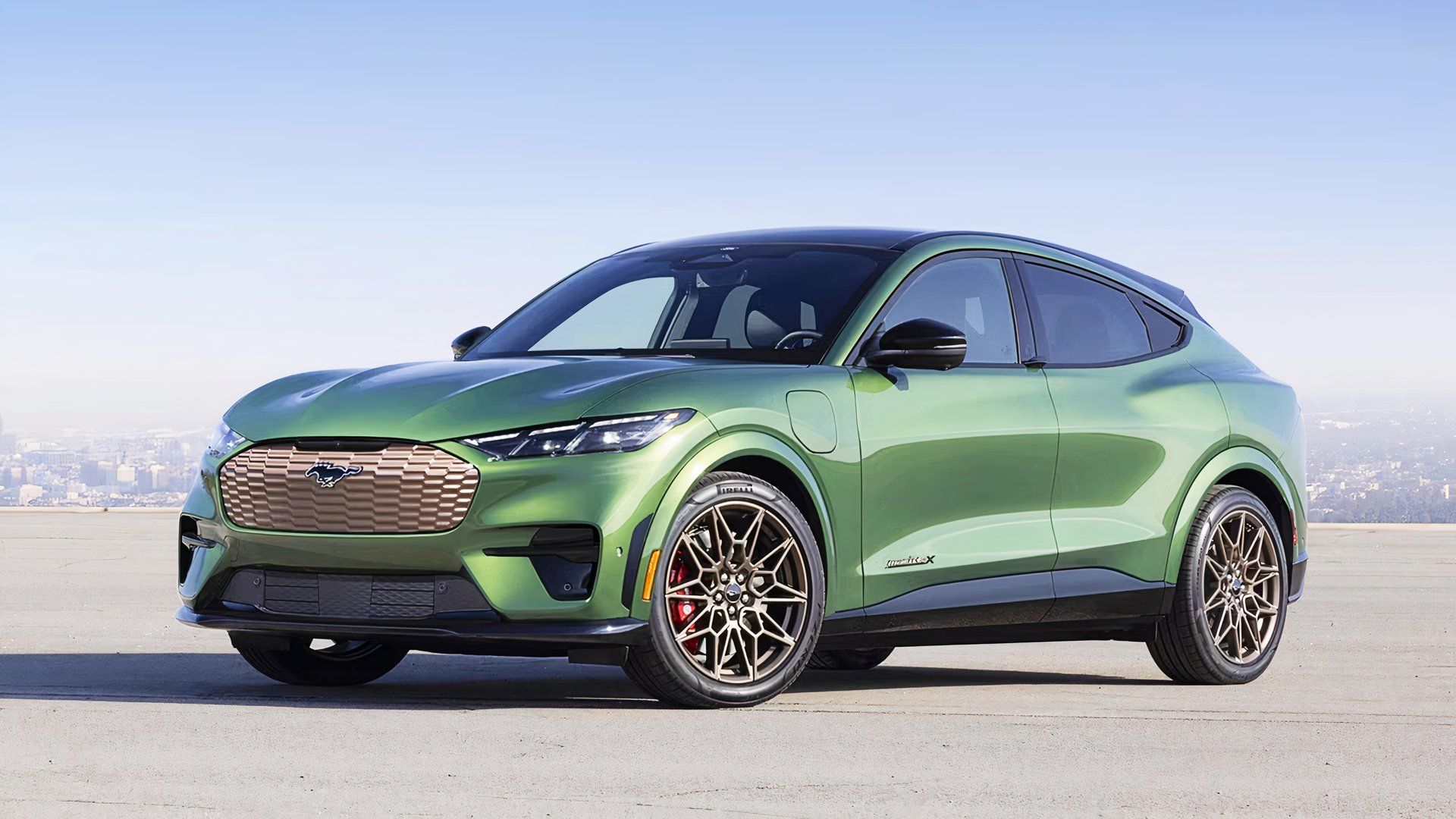 A green 2024 Ford Mustang Mach-E small electric SUV is parked. 