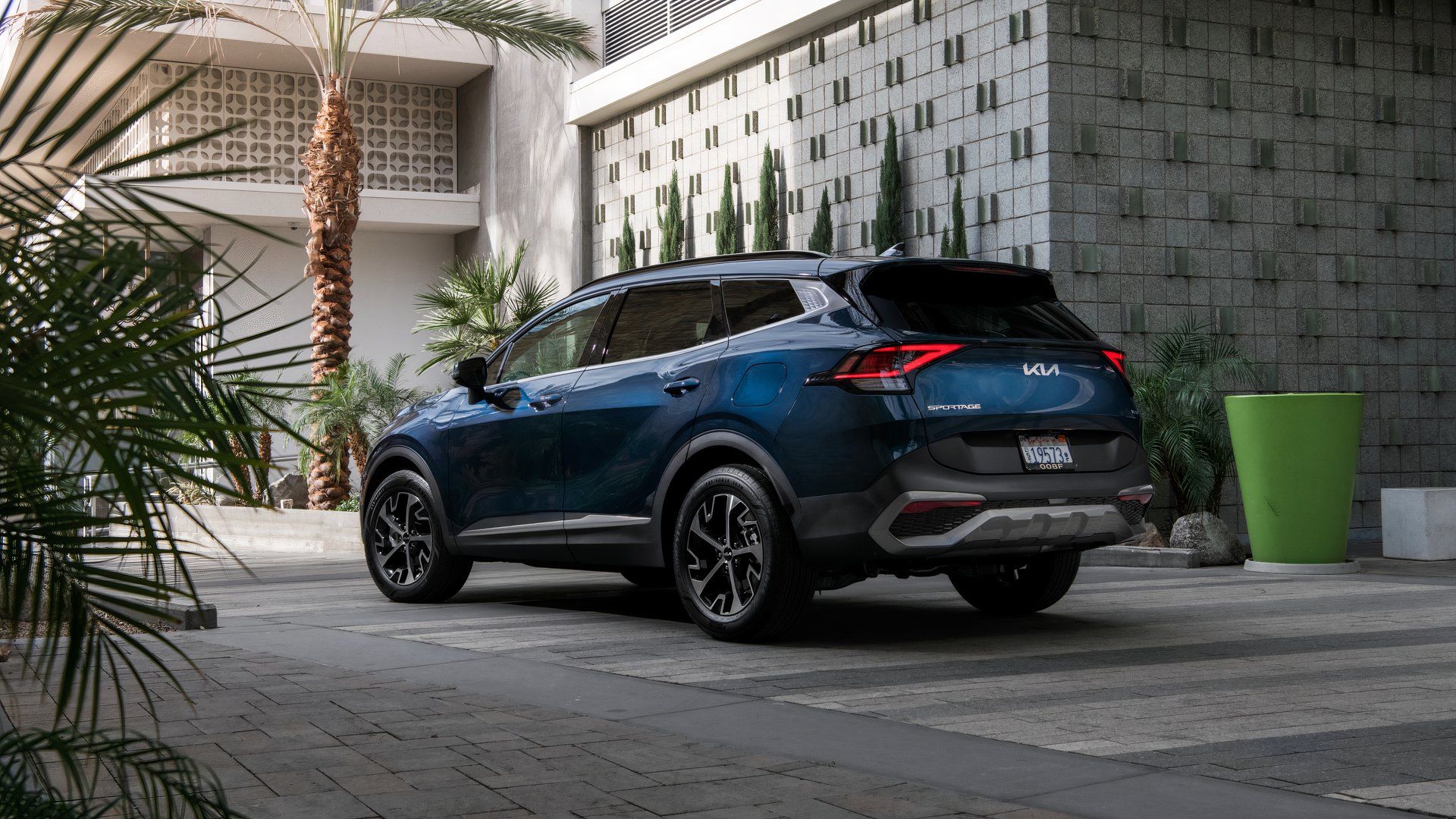 A rear three-quarter view of a 2025 Kia Sportage Hybrid