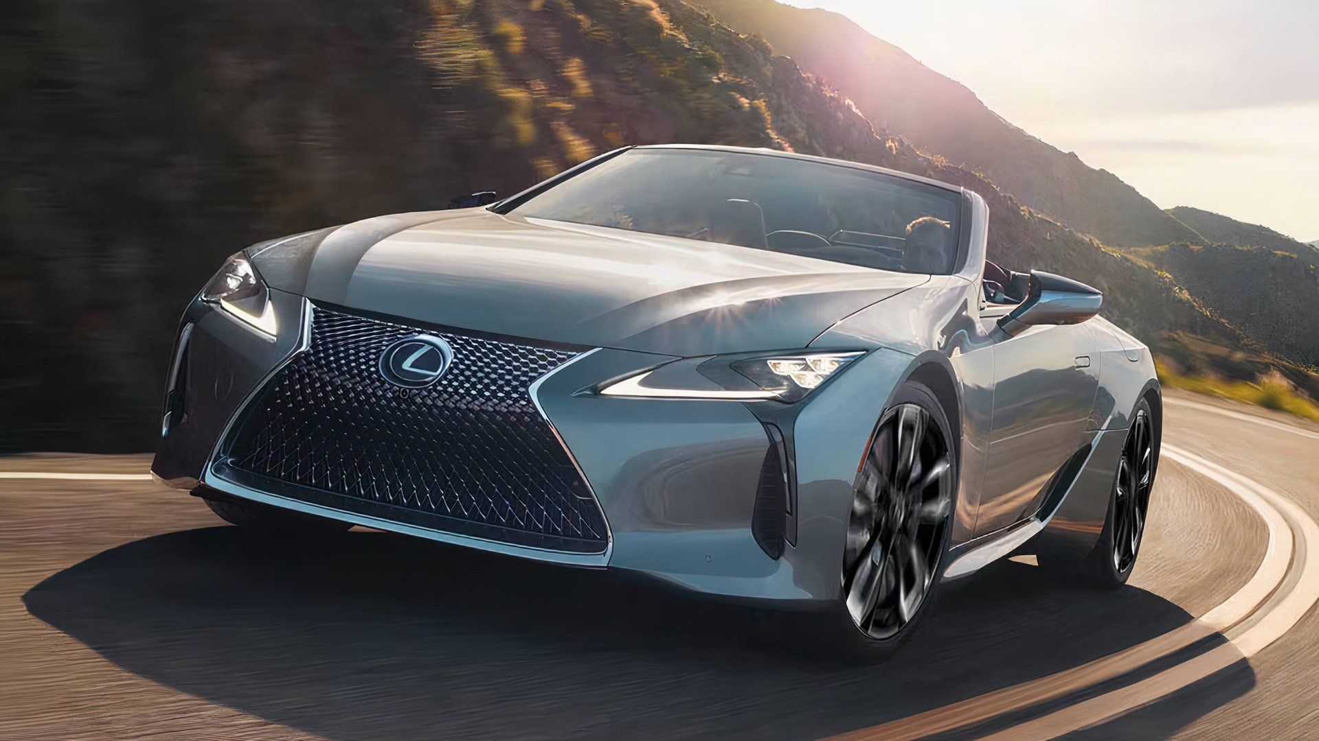 2025 Lexus LC 500 in silver driving along Mountain Road