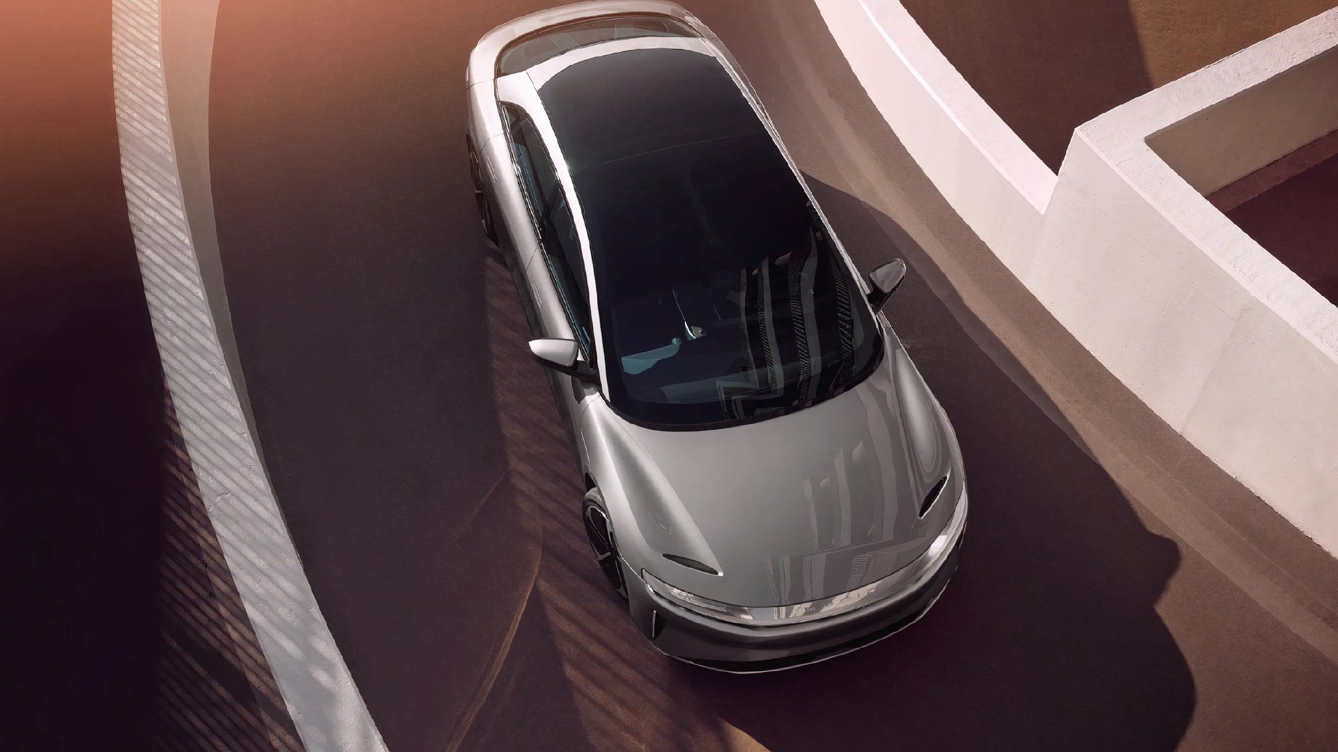 A gray Lucid Air Pure is parked. 