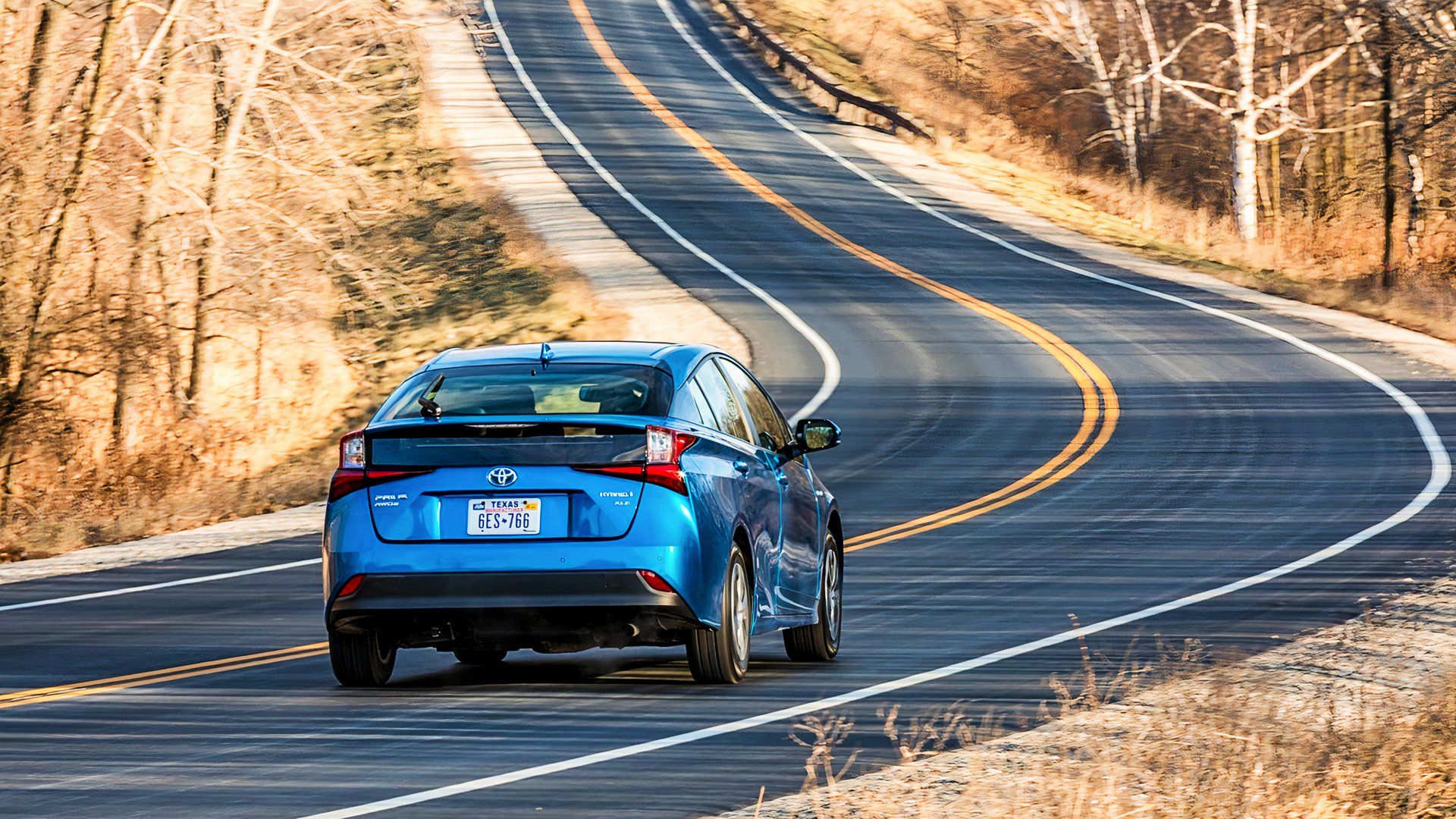 The rear of a blue 2020 Toyota Prius. 