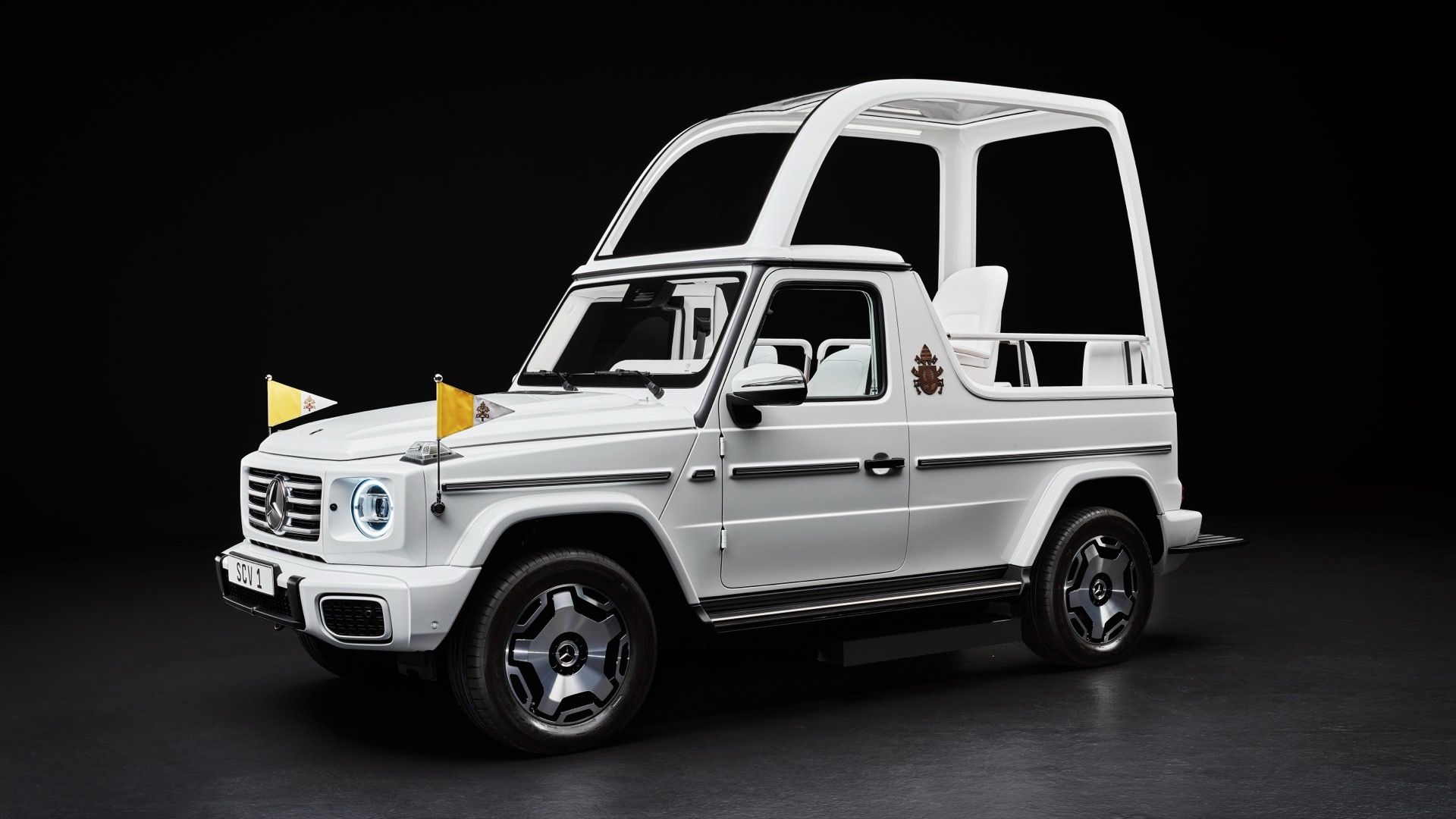 Front three-quarters photo of electric Mercedes-Benz G-Class Popemobile for Pope Francis, with roof