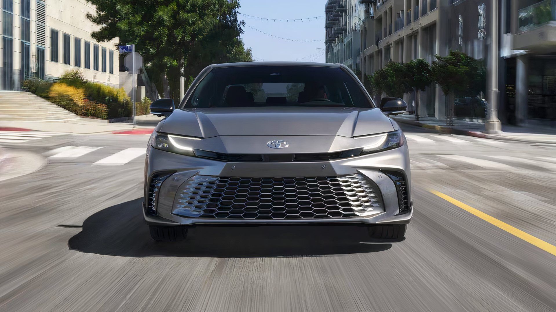 2025 Toyota Camry XSE in silver driving along city road