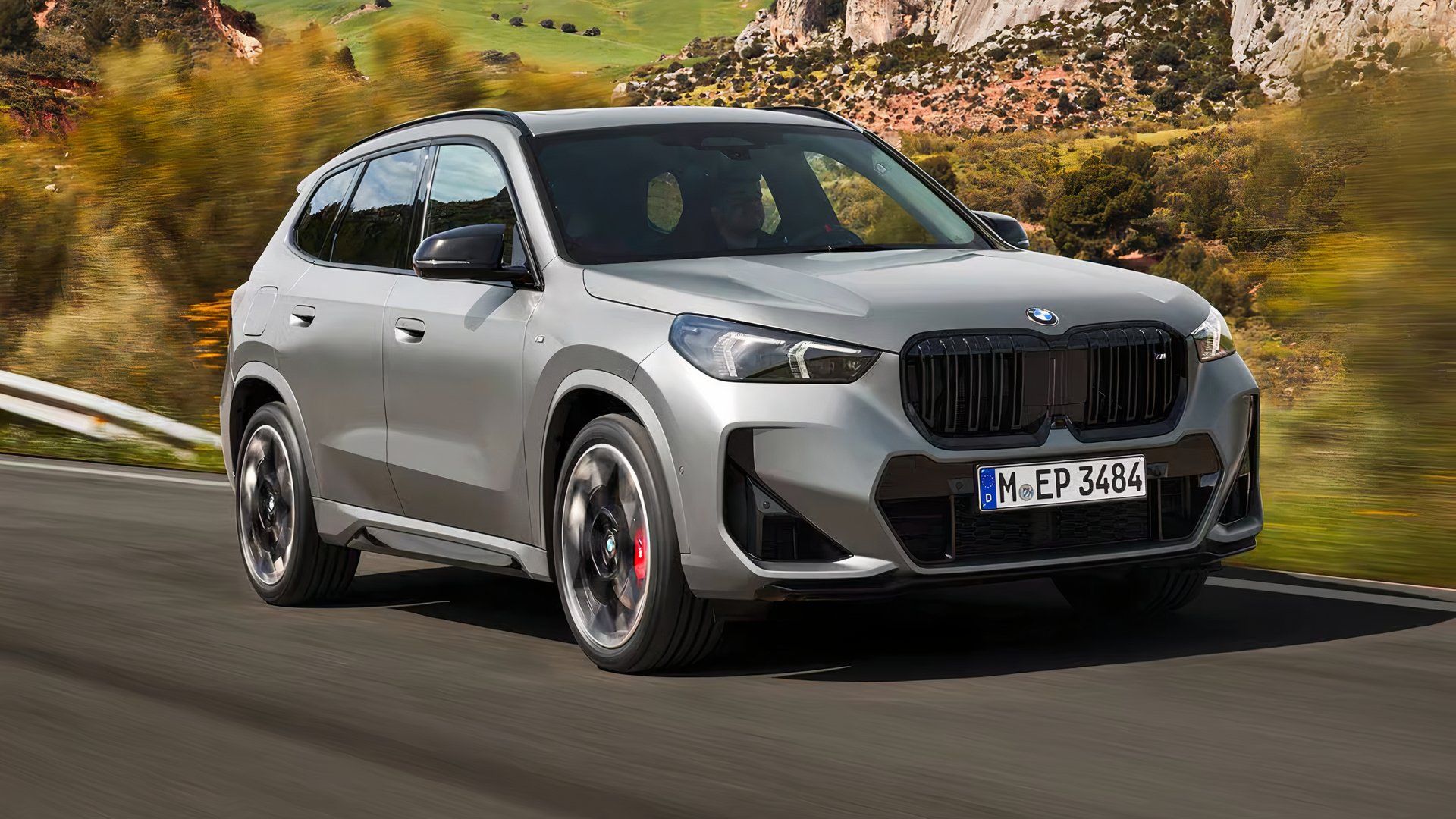 2025 BMW X1 M35i in silver driving on country road
