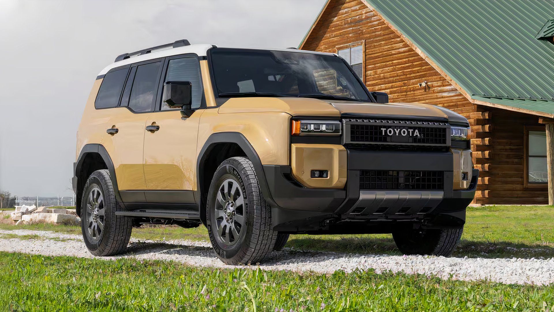 2025 Toyota Land Cruiser in brown parked on gravel road outside of house