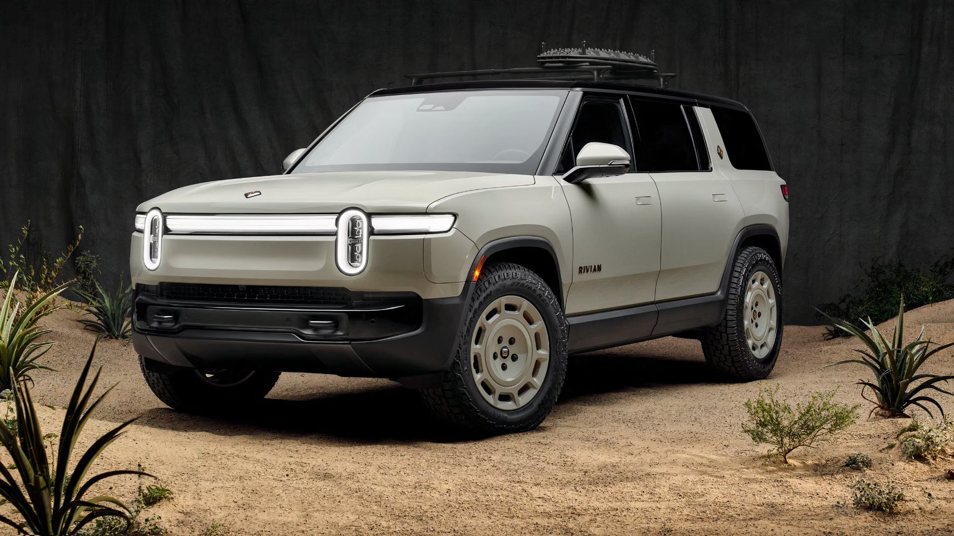 Exterior front three-quarters static photo of a gray 2025 Rivian R1S California Dune Edition