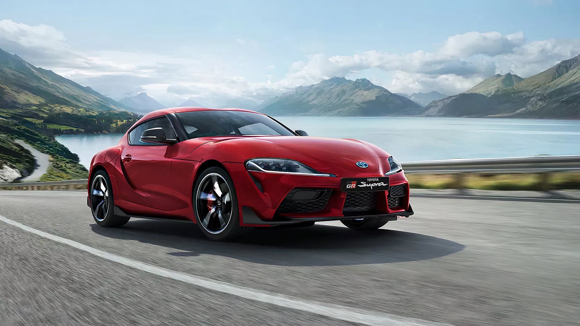 2024 Toyota GR Supra 3.0 Premium in red driving on lake road