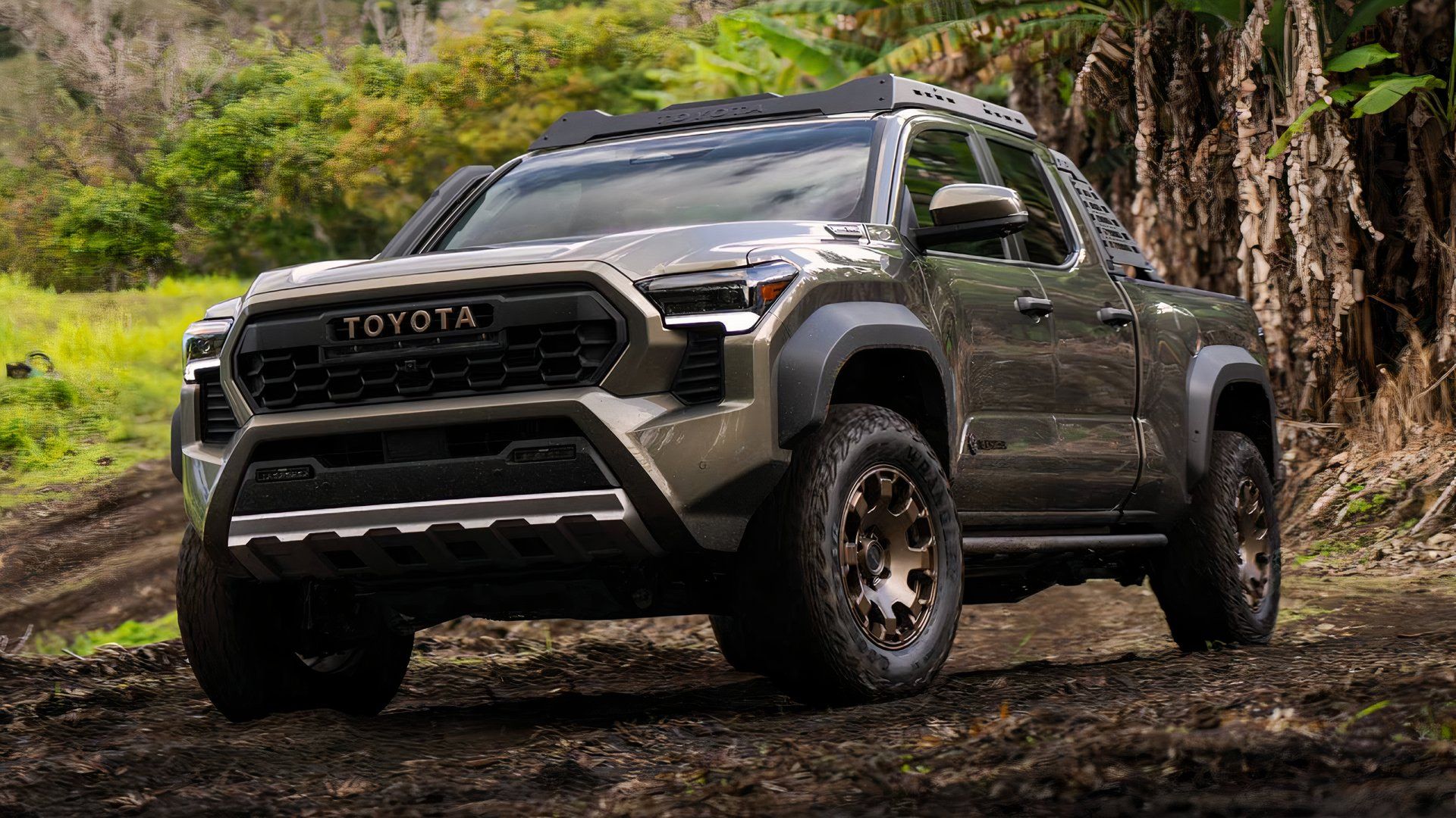 2025 Toyota Tacoma Trailhunter Crew Cab in green parked in forest off-road