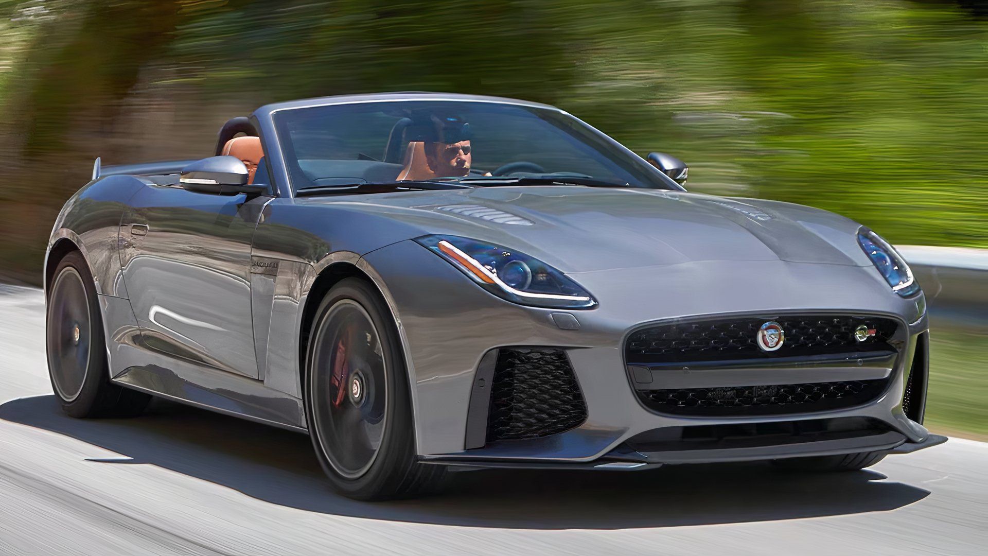 2017 Jaguar F-Type in gray driving with roof down