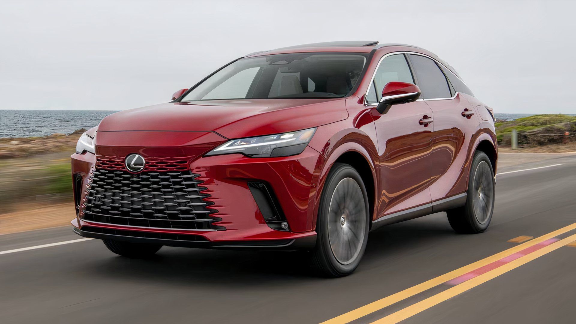 2025 Lexus RX 350h Premium in red driving on coast road