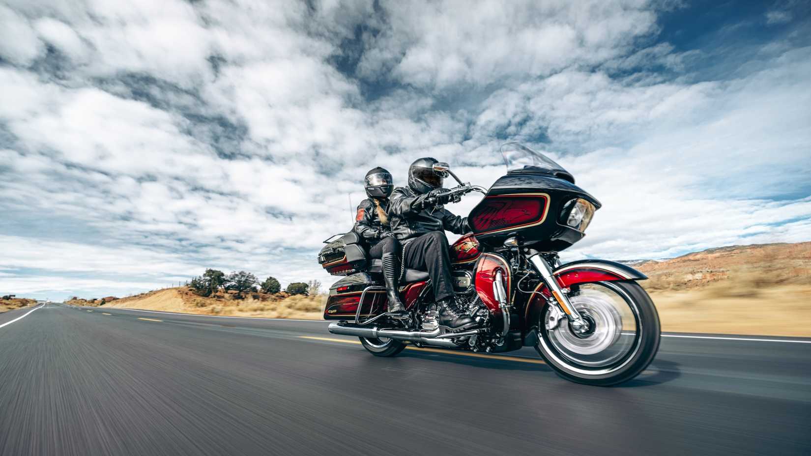 2023 Harley-Davidson CVO Road Glide Ltd Anniversary with two riders going down the road in the desert