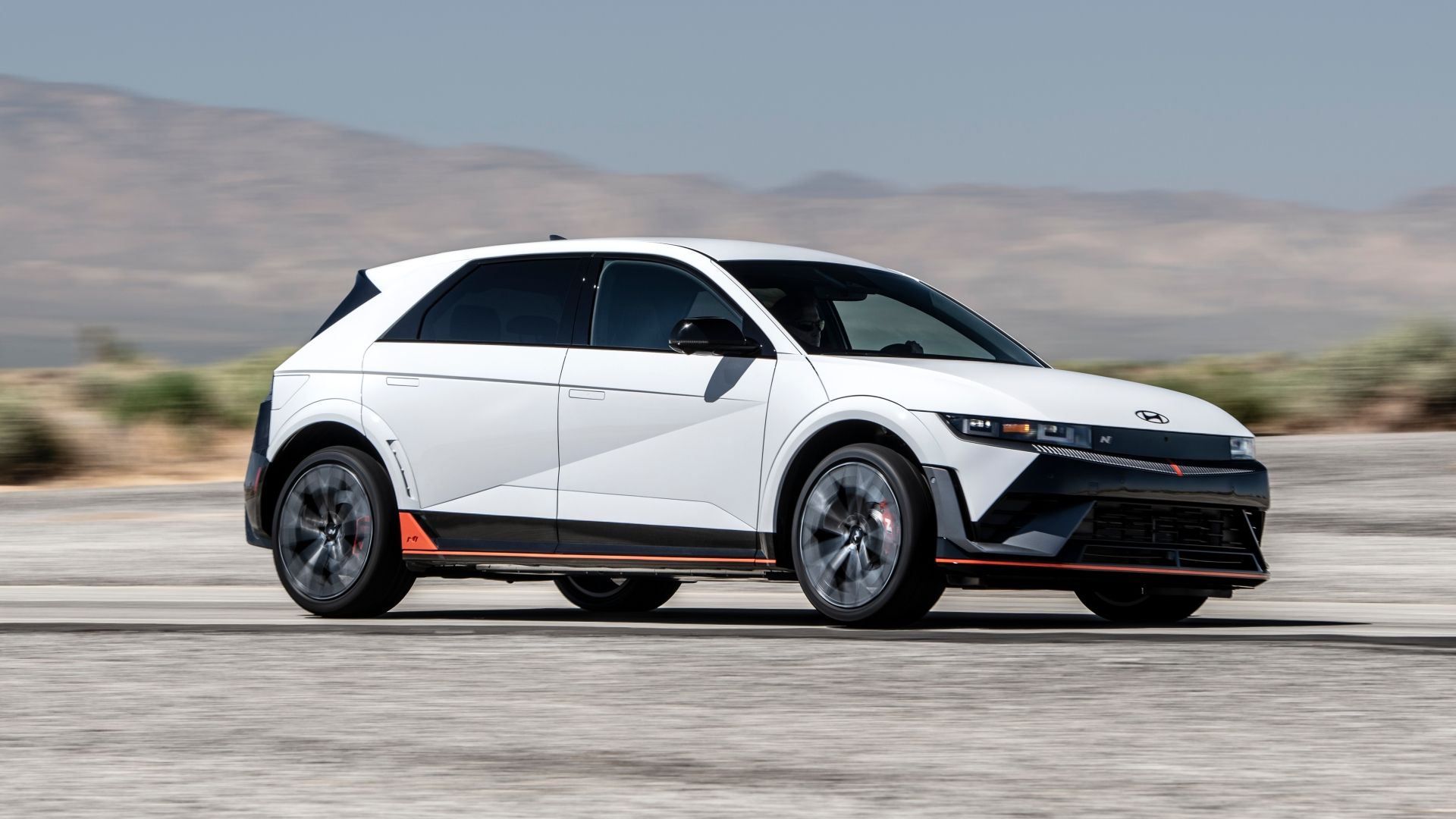 Front three-quarters driving image of a white 2025 Hyundai Ioniq 5 N