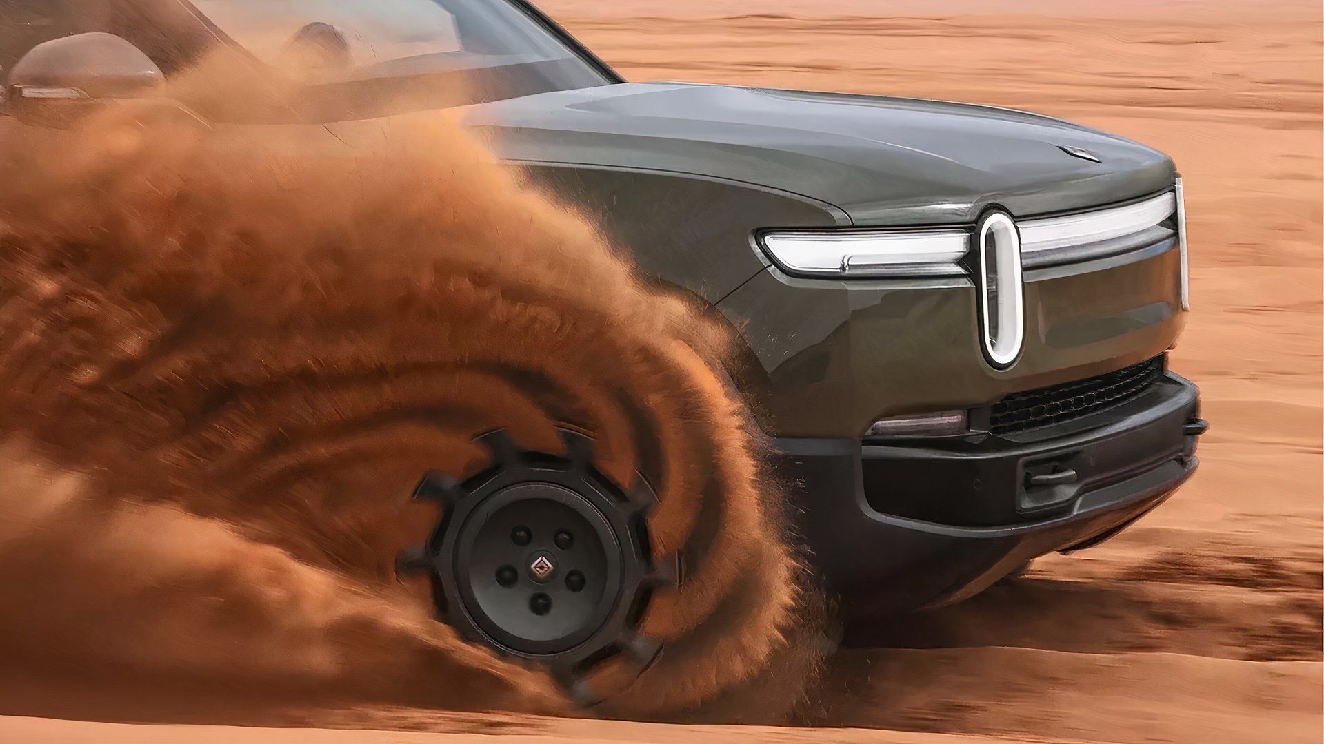 A 2026 Rivian R1T Quad kicking up dust