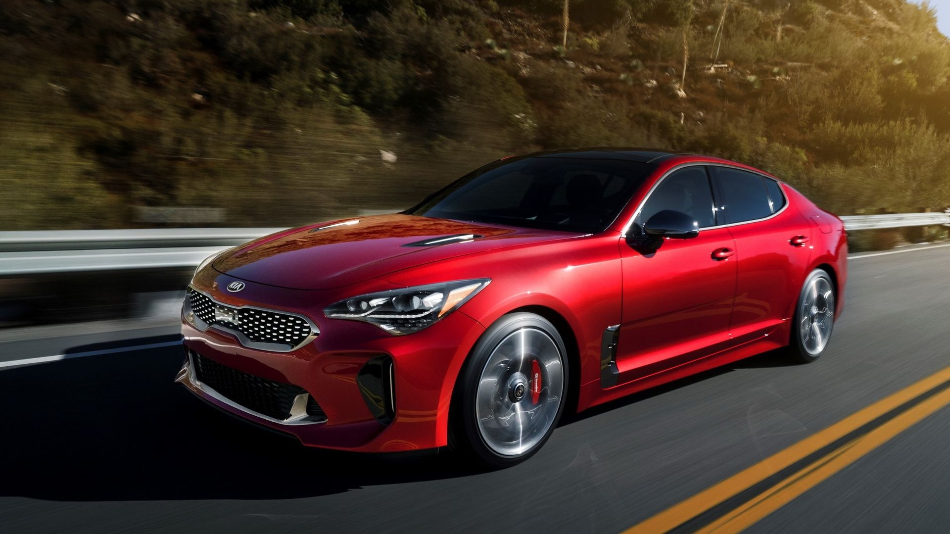 red Kia Stinger GT driving in a straight line