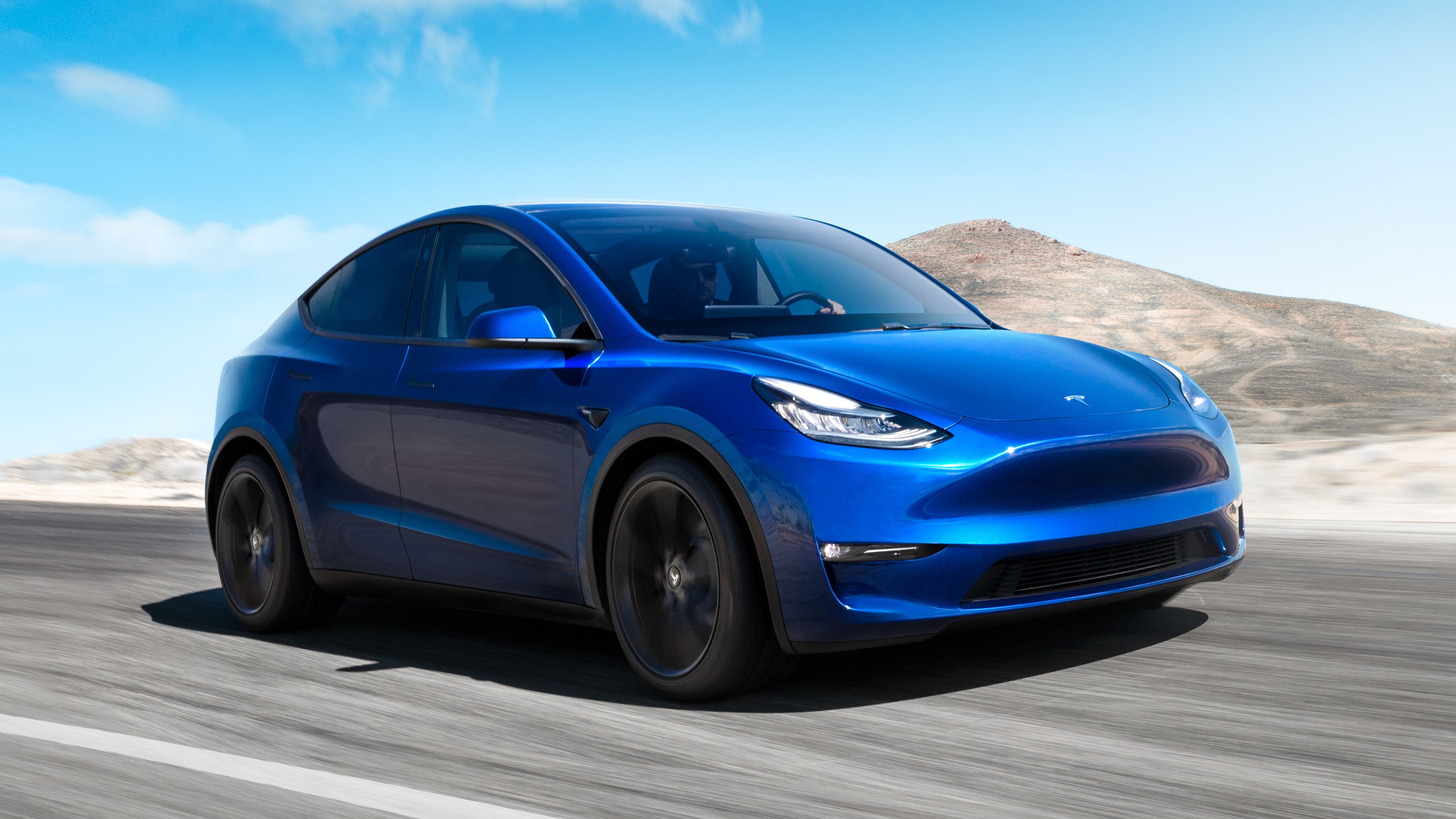 Blue Tesla Model Y Driving