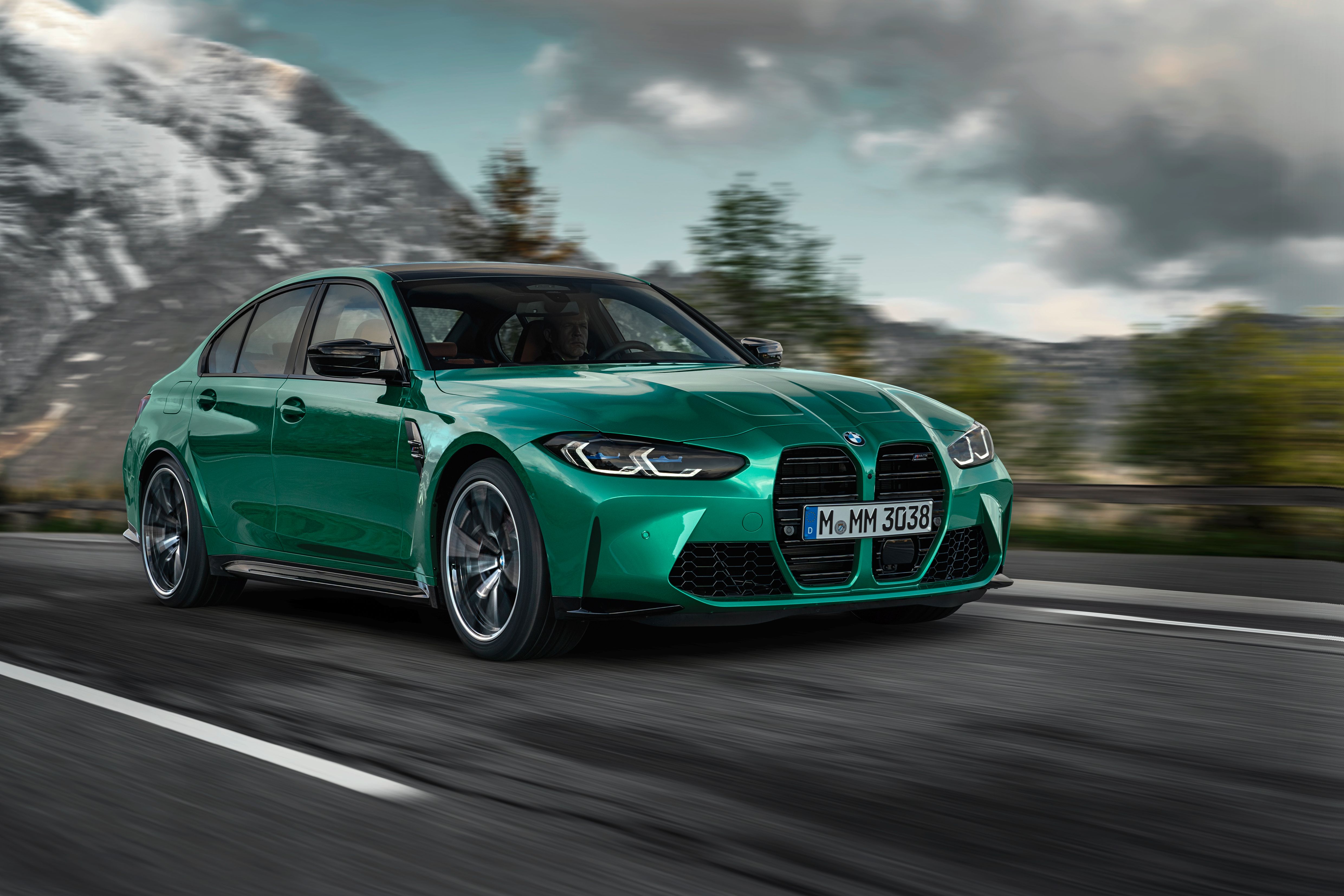 green 2021 BMW M3 Competition driving