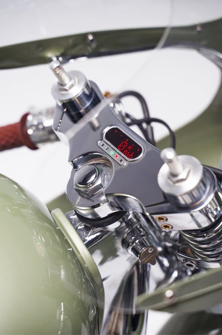 An exploded view of a triumph cafe racer suspended by aircraft cable in a lucky  brand jeans store : r/MotorcyclePorn