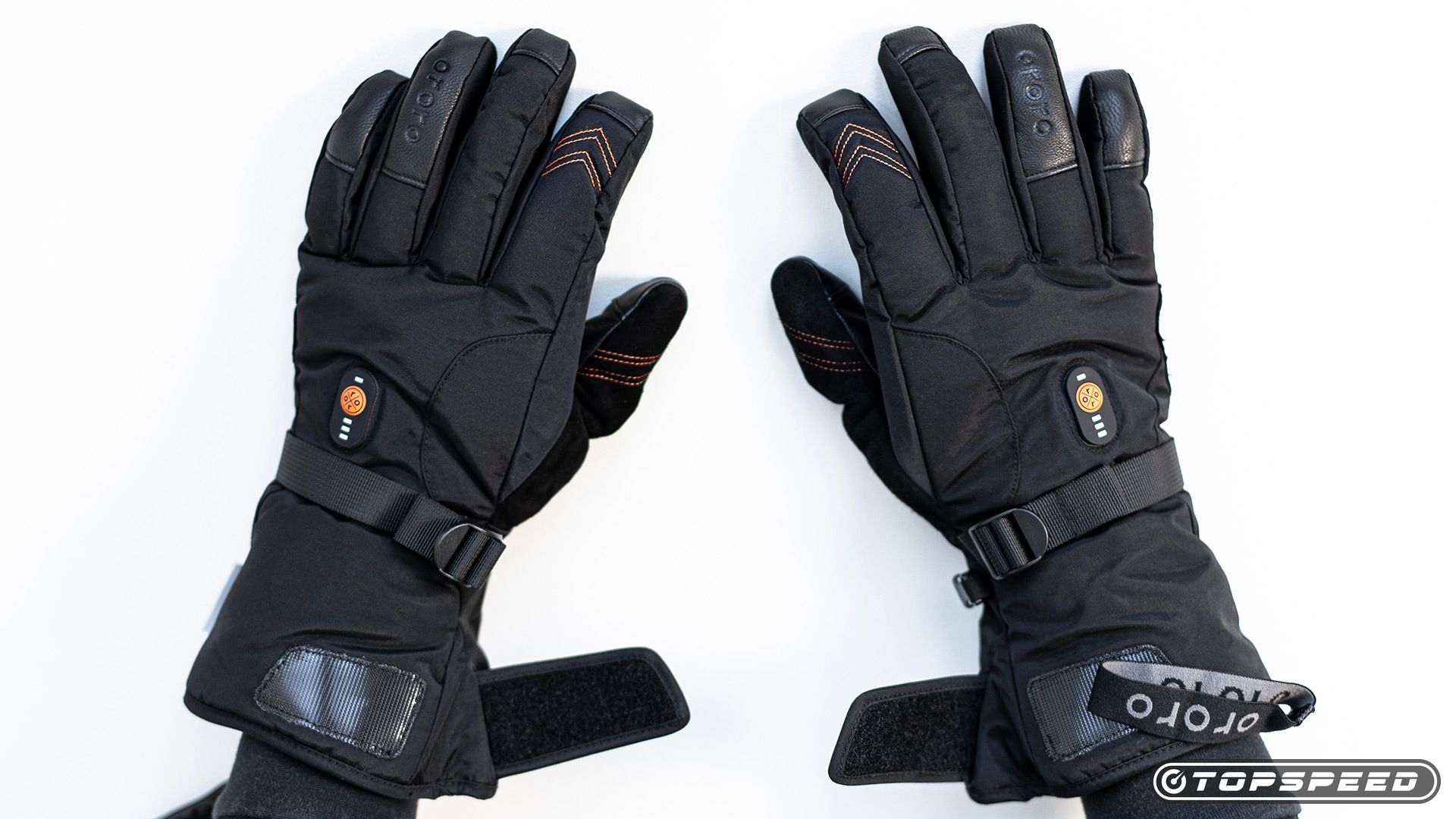 Photograph of ORORO Heated Gloves over motorcycle handlebars in a motorcycle garage