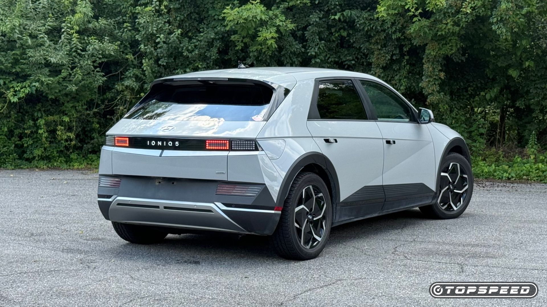 A stationary rear three-quarters image of a gray 2022 Hyundai Ioniq 5 SE