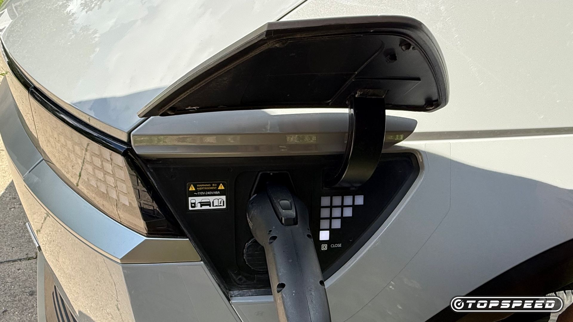 The charging port of a gray 2022 Hyundai Ioniq 5 SE with plug
